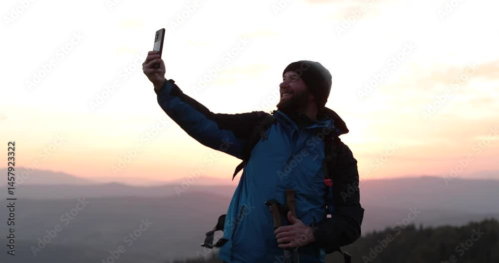 Solo traveler standing on a mountainside talking via video call. Remote communication in the wilderness, solitude and technology come together. Solo traveler standing on a mountainside talking via video call. Remote communication in the wilderness, solitude and technology come together.