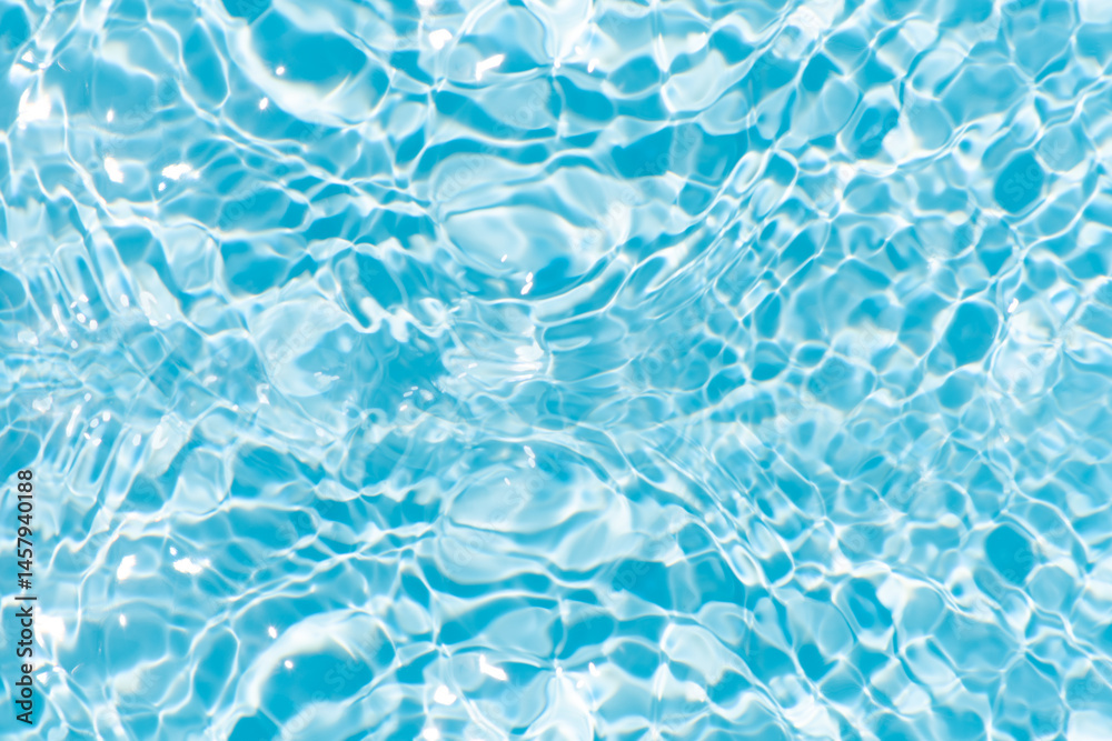 Obraz premium Blue water with ripples on the surface. Defocus blurred transparent blue colored clear calm water surface texture with splashes and bubbles. Water waves with shining pattern texture background.