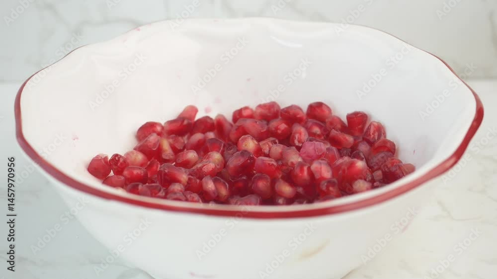 Enjoy a bowl of freshly prepared pomegranate seeds, perfect for snacking Enjoy a bowl of freshly prepared pomegranate seeds, perfect for snacking