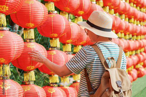 Female tourist enjoying view of traditional Chinese red lanterns