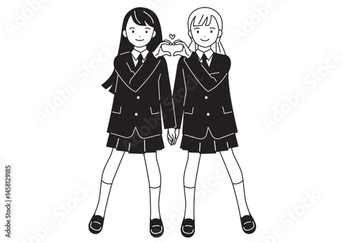 指でハートマークを作るポーズの女子学生