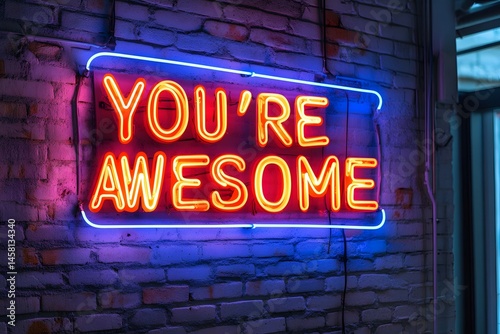 Vibrant neon sign displays the inspirational message you're awesome against a brick wall background.