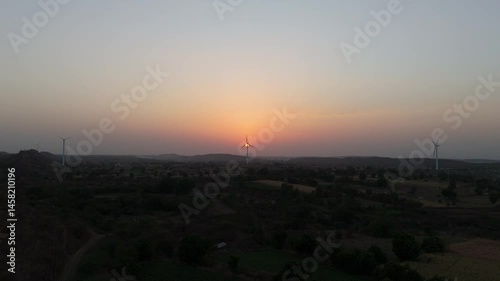 Beautiful evening view of wind turbine near evening sun.  Renewable energy.