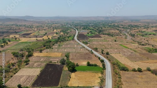 Beautiful aerial view of RCC Road surrounded by agriculture  field located in Nandurbar district Maharashtra State, India.