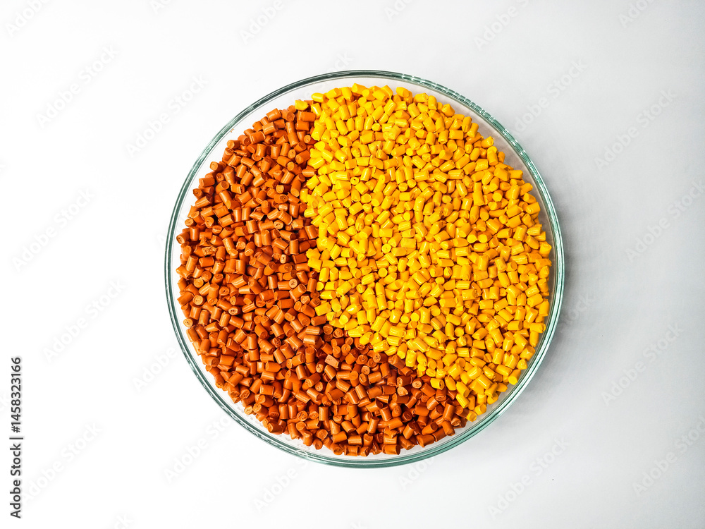 Yellow, orange polymer granules, masterbatch granules, cold cutting material type, isolated on white background for product catalog design of plastic manufacturing industry company profile Yellow, orange polymer granules, masterbatch granules, cold cutting material type, isolated on white background for product catalog design of plastic manufacturing industry company profile