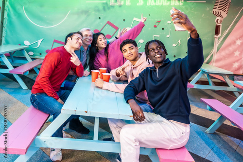 Obraz na płótnie Multiethnic friends taking selfie at bowling alley cafe w salonie