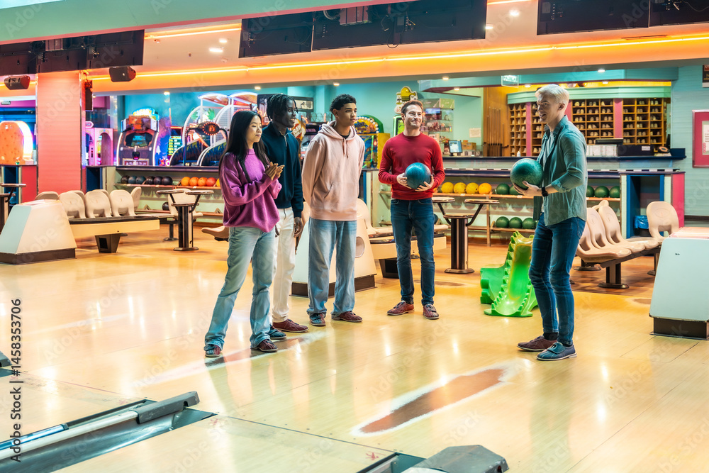 Friends playing bowling at entertainment center