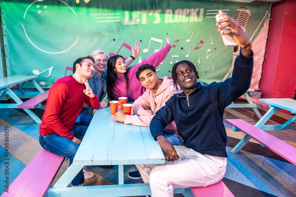 Friends taking selfie at bowling alley cafe