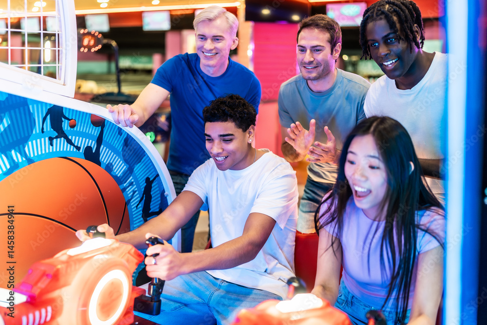 Friends playing arcade basketball game together in entertainment center