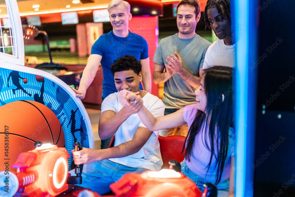 Friends playing arcade basketball game and having fun together