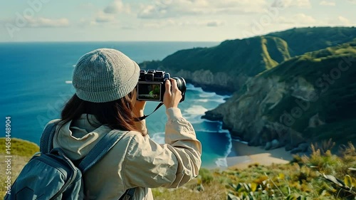 Woman photographer taking pictures of scenic coastal view
