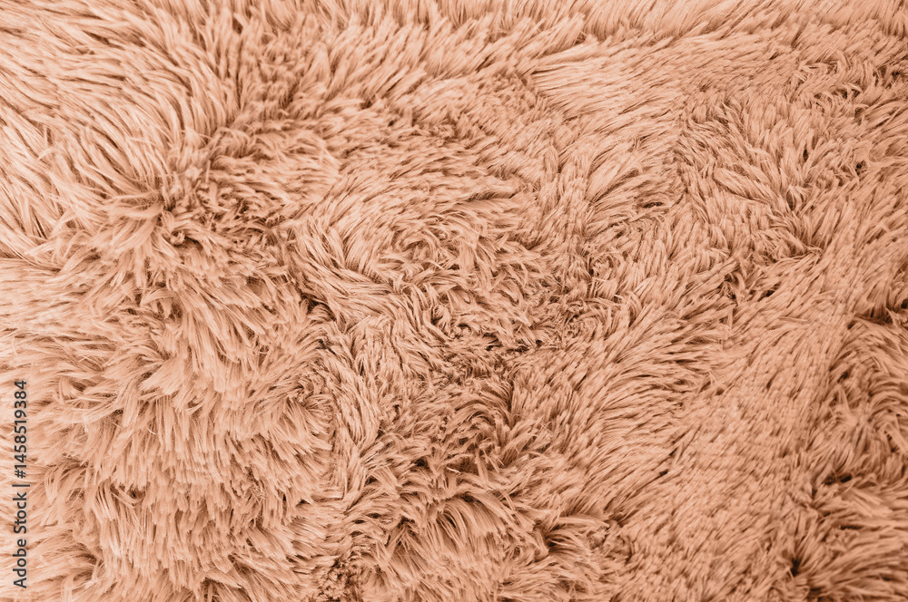 A close-up shot showing the intricate details of a plush, fluffy, brown fabric texture.