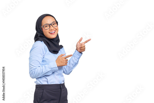 Portrait of smiling young Asian woman pointing finger at copy space isolated on transparent background