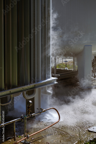 An oxygen station that produces and supplies medical oxygen to a hospital. The station includes radiators and a large white cylinder containing liquefied oxygen for distribution.