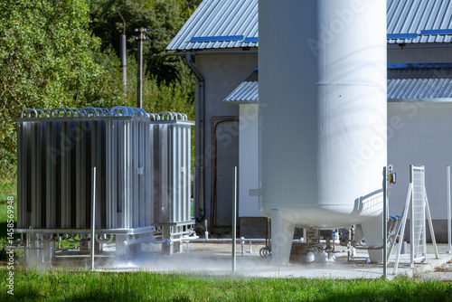 An oxygen station that produces and supplies medical oxygen to a hospital. The station includes radiators and a large white cylinder containing liquefied oxygen for distribution.