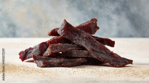 Savory Dried Meat Sticks Stacked on White Wooden Table Surface