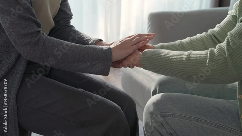 Psychologist, friend or family holding hands to encourage patient with depression, anxiety, therapy session, mental health concept