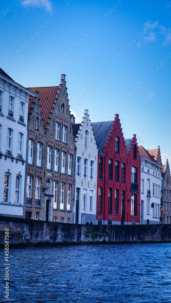Naklejka premium Medieval buildings along a canal in Bruges, Belgium