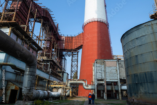 Obraz na płótnie A massive gas exhaust system at a high-capacity thermal power plant. Towering red-and-white chimneys exceed 150 meters in height, facilitating emissions management and industrial air circulation. w salonie