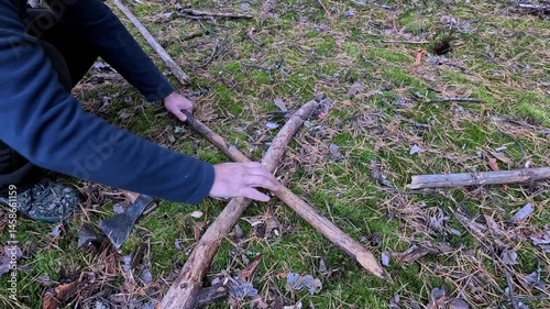 Cut a stick in half with a metal axe in the forest