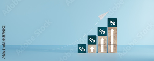 Wooden blocks with percentage signs showing an upward trend, concept of interest growth.