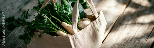 
Close-up of cloth tote bag filled with local organic vegetables on a rustic table, bright light, sustainable summer market haul