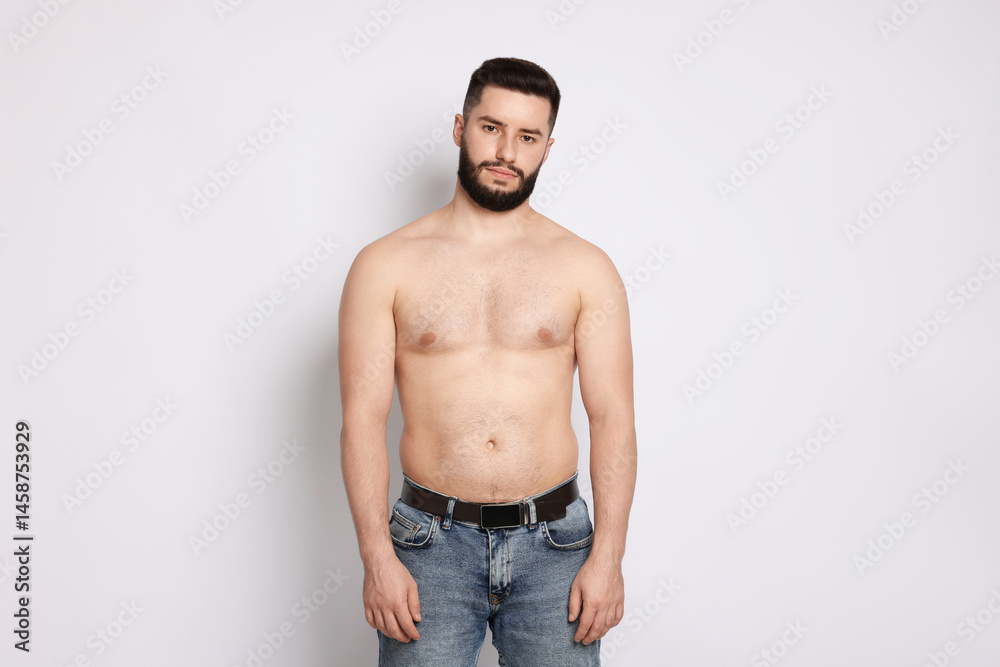Fototapeta premium Man after weight loss on light background
