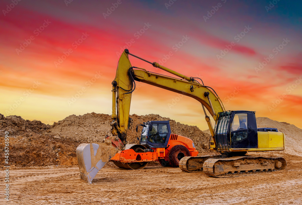 Obraz premium Soil Compactor the leveling soil at construction site. Excavator and vibration single-cylinder road roller during the construction of roads