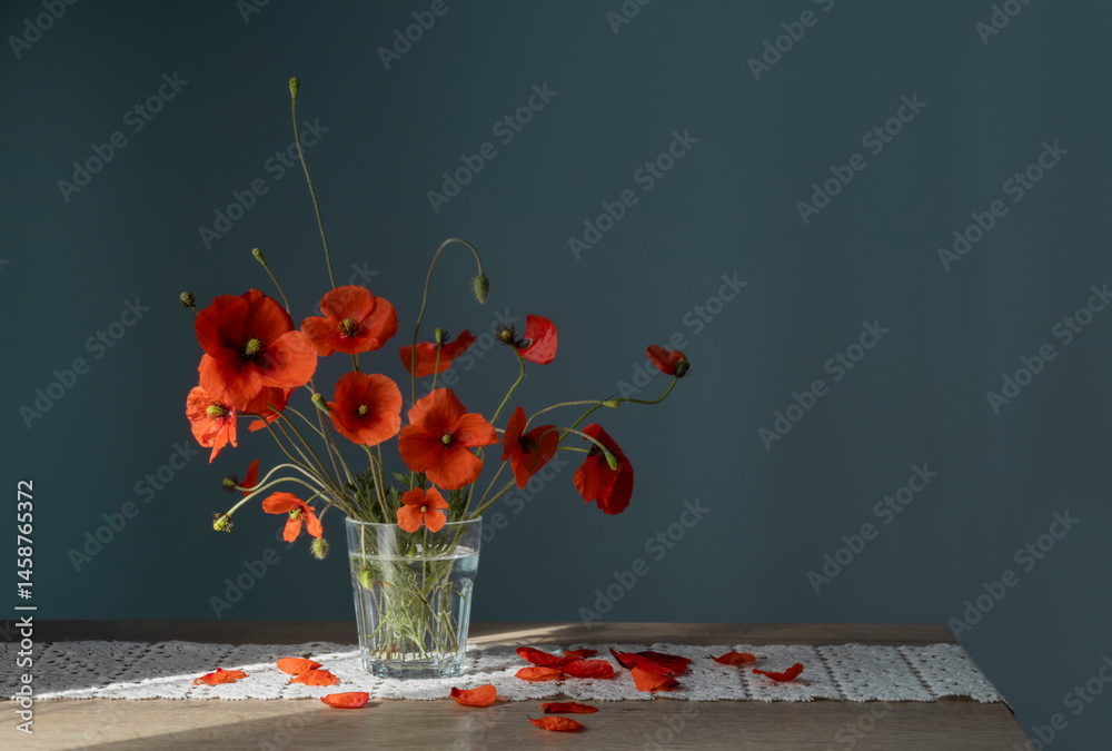 bouquet of red poppies in glass