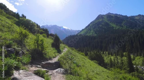 This footage shows a trail in Ala Archa National Park, Kyrgyzstan, inviting viewers to explore the natural beauty of the area along a well-maintained hiking path.