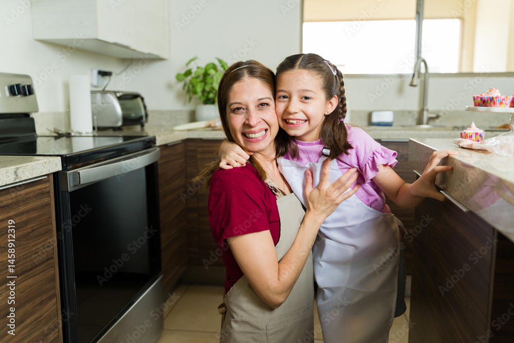 Happy mother and daughter baking together in modern kitchen