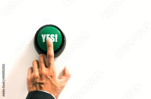 person presses the green button to confirm agreement, signaling approval and acceptance of a decision in voting or selection process.