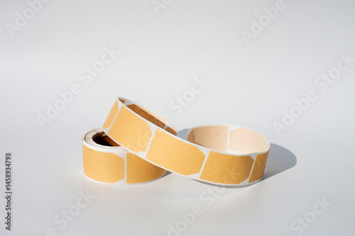 Yellow adhesive label rolls on white background