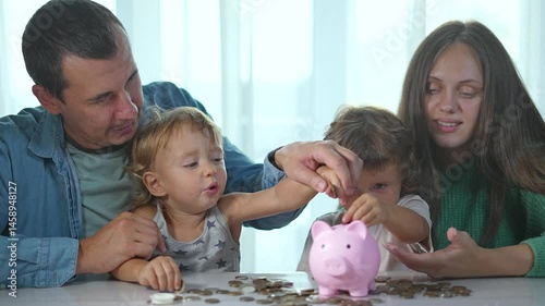 Mother teaching child about budget. Family saving money with piggybank for mortgage. Child learning financial responsibility. Coin being saved budget planning. Family mortgage savings with piggybank.