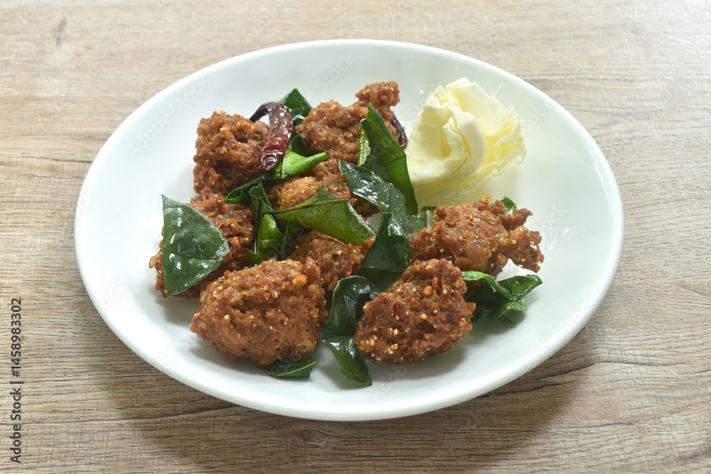 deep fried spicy chop pork ball Thai salad taste spicy and sour with cabbage on plate