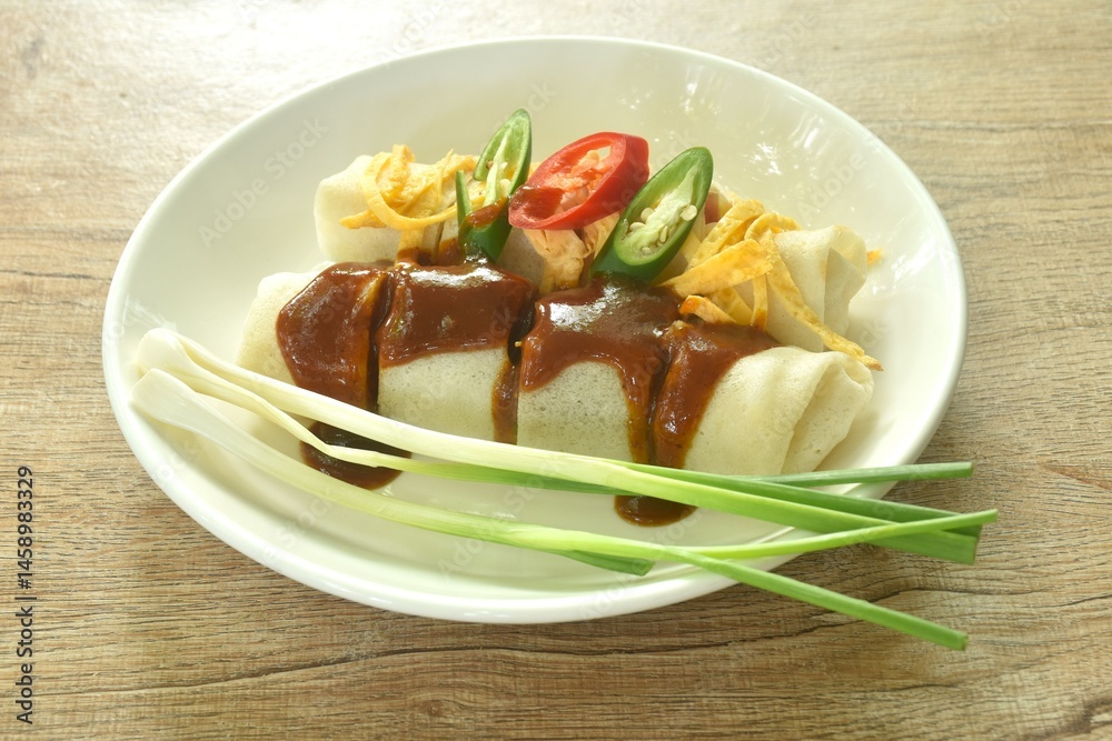 fresh Chinese spring roll made from flour wrapped tofu and pork with bean sprout dressing sweet red gravy sauce on plate