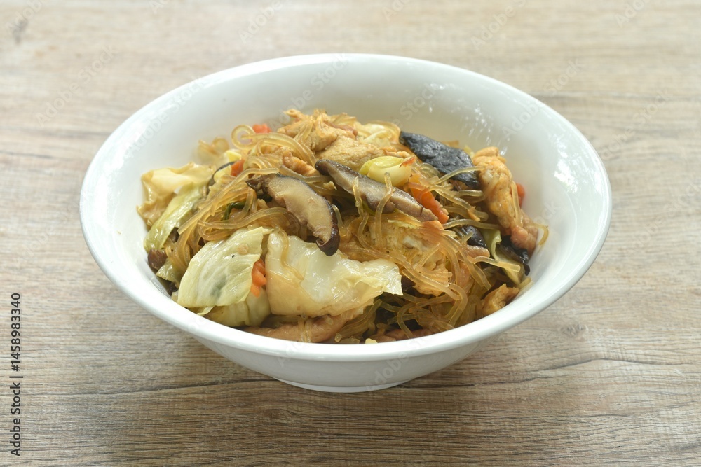 fried glass noodles slice pork and cabbage with egg on bowl