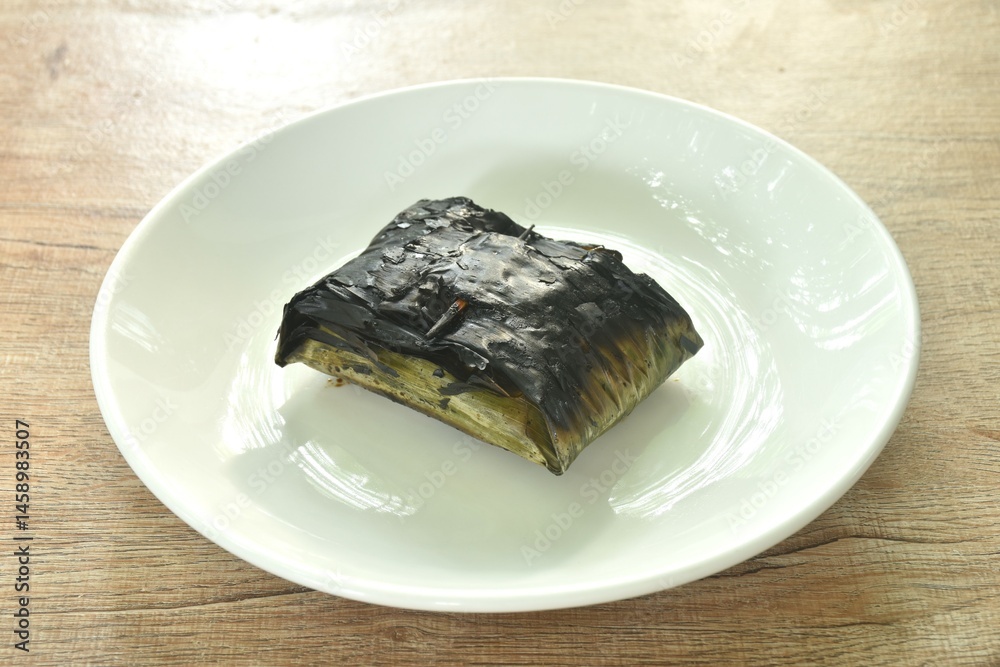 grilled chop pork curry in banana leave Thai northern food on plate