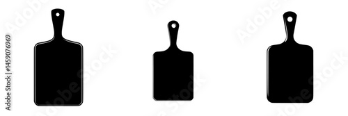 Set of flat black kitchen cutting boards arranged in a row showcasing different sizes for food preparation and presentation