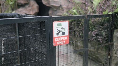 Footage of keeper only signage on animal cage at the zoo