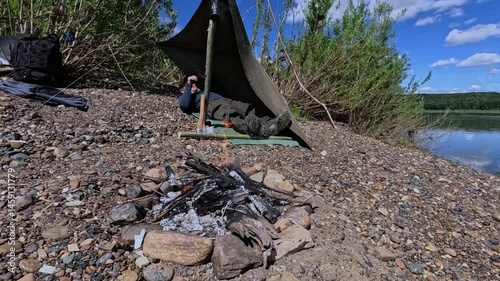 A tourist sleeps outdoors in the forest