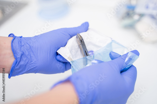 A Medical Professional Preparing Instruments Carefully in a Clean Clinical Setting Environment
