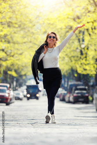 Wallpaper Mural Dynamic scenic young adult pretty happy woman enjoy walk spring Magdeburg city Hegelstrasse Hegel street road green tree alley perspective background. Female person carefree portrait smiling outdoors Torontodigital.ca