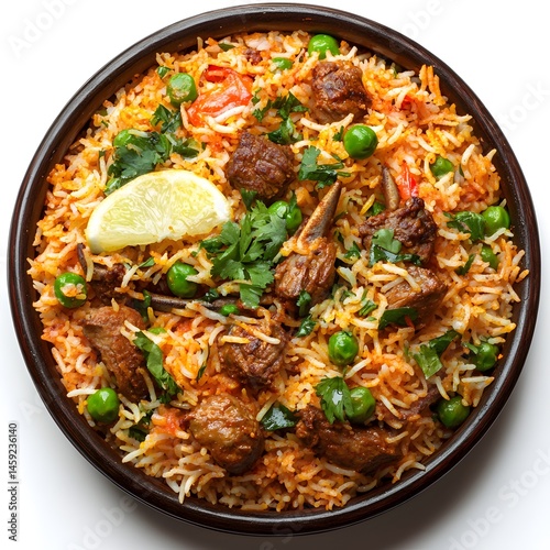 A delicious and aromatic lamb biryani dish is served in a dark brown bowl garnished with fresh lemon and cilantro.