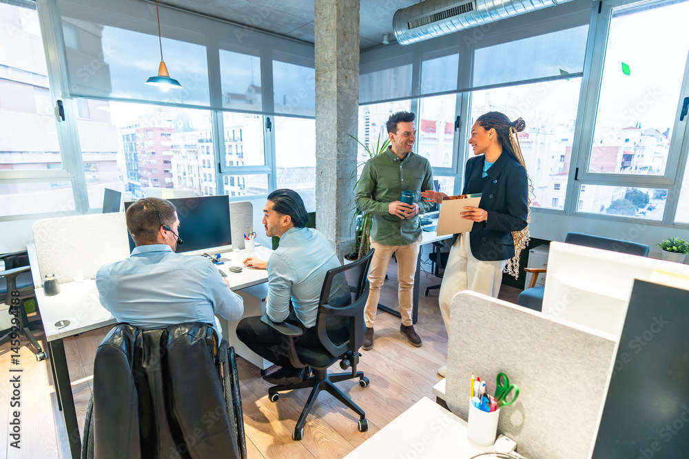 Diverse businesspeople collaborating in modern office with wheelchair user