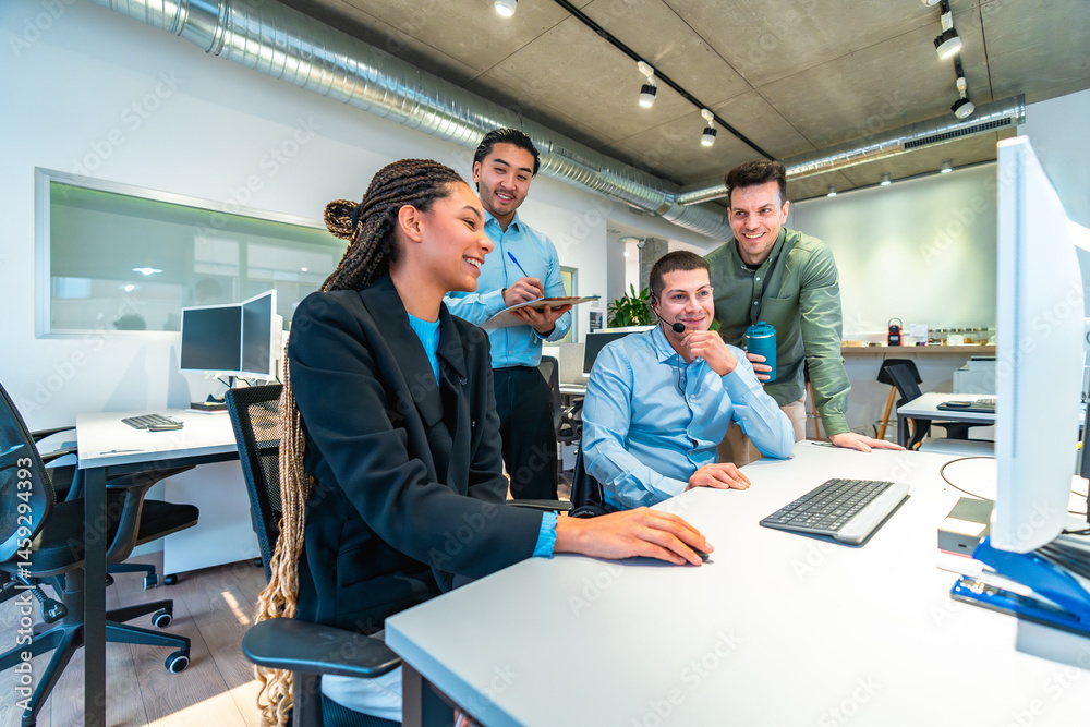 Business team collaborating on computer in modern office