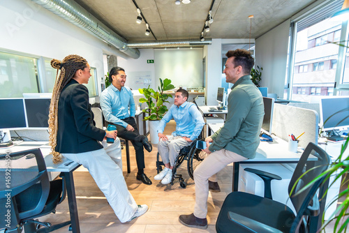 Wallpaper Mural Diverse business team discussing in modern office with disabled colleague in wheelchair Torontodigital.ca