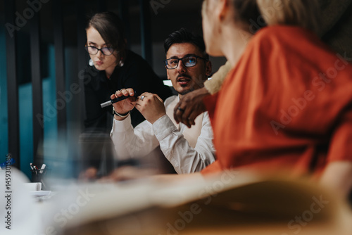 Εκτύπωση καμβά Business people engaged in a lively discussion, showcasing teamwork, creativity, and innovative thinking in a modern office setting