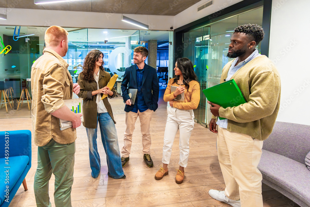 Startup businesspeople discussing work in office hallway