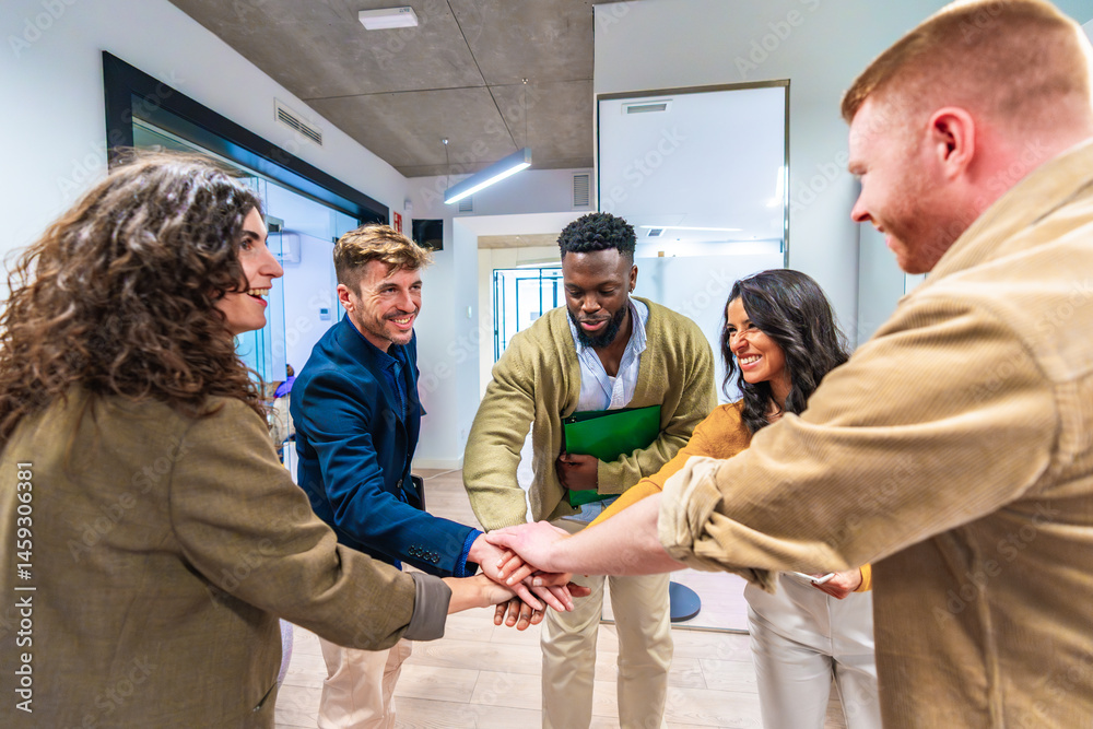 Startup business team joining hands in modern office, celebrating success and teamwork